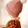 Designbeispiel für die Mütze "Funky Head" von Schleiferlwerk in rosa mit weißem Bommel
